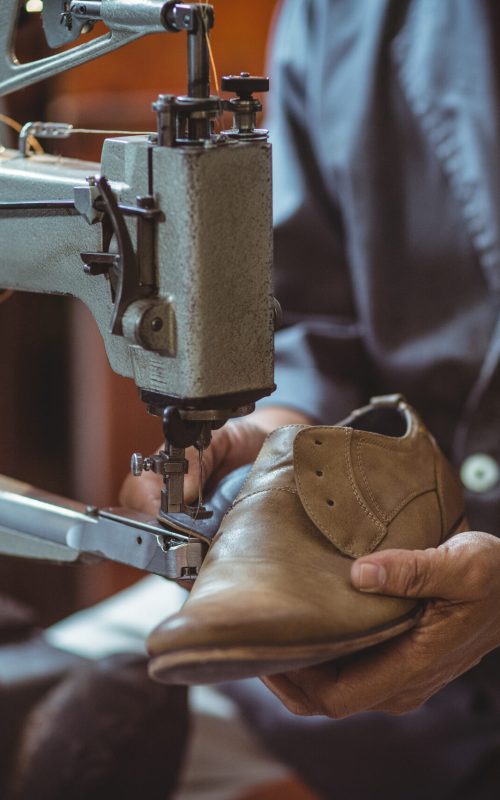 shoemaker-using-sewing-machine-in-workshop-2025-10-28-21-52-10-utc